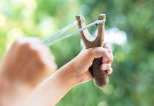 Why More South Africans Are Choosing Slingshots for Recreational Shooting Hand shooting a slingshot during outdoor target practice using equipment from GX Slingshots online store